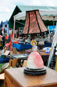 lamp with woman porcelain figure on cabinet at flea market